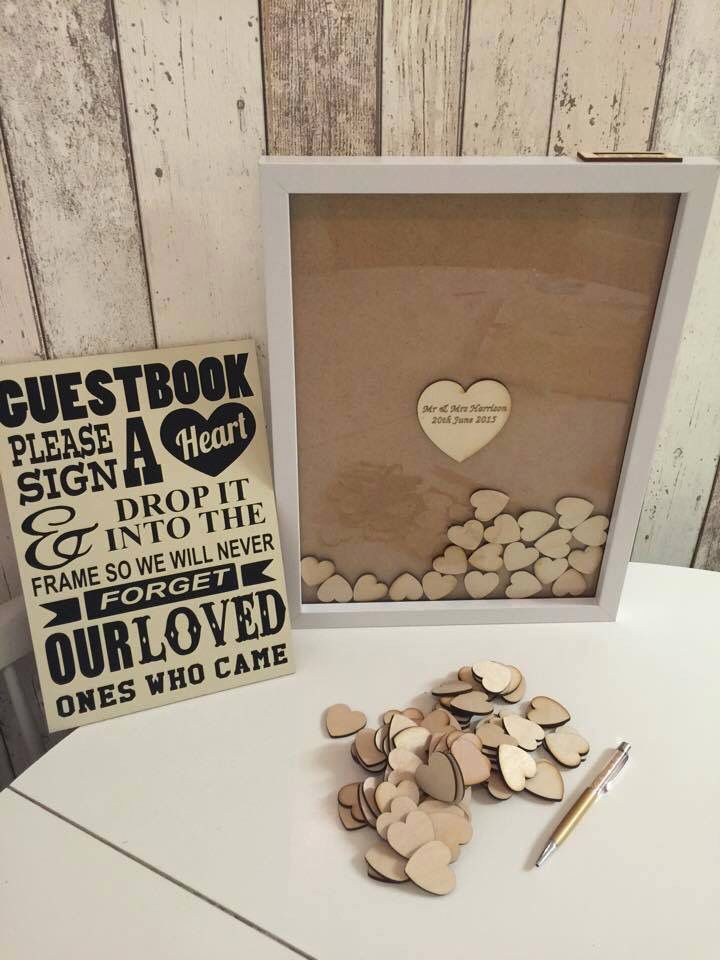 Better than guest book. Have guests write on the little hearts and put them in the frame so everyone will remember.